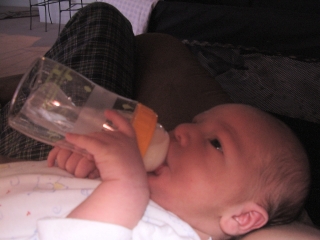 Holding my bottle - pretty smart looking for less than 10 days old!